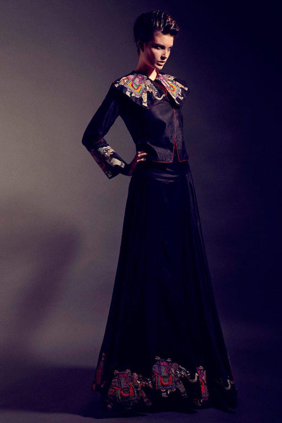 A long black tailored coat with an embroidered hem