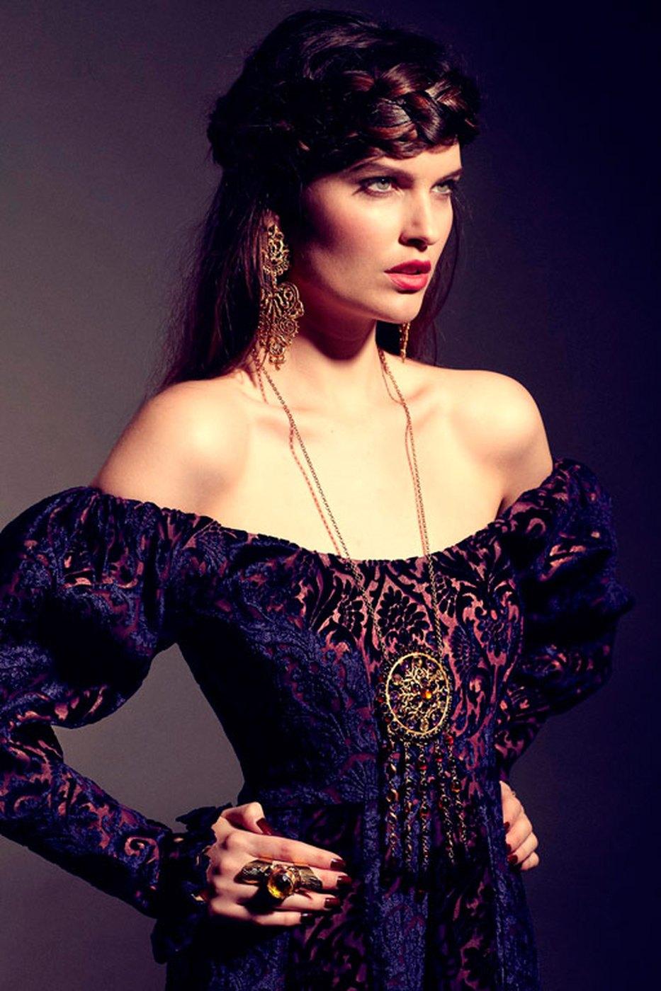 A portrait in an embroidered off-shoulder gown