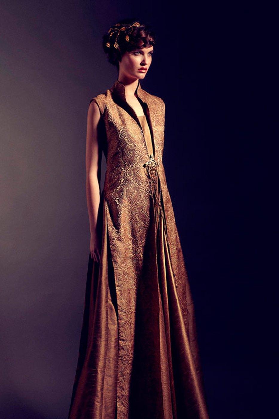A gold textured floor-length coat