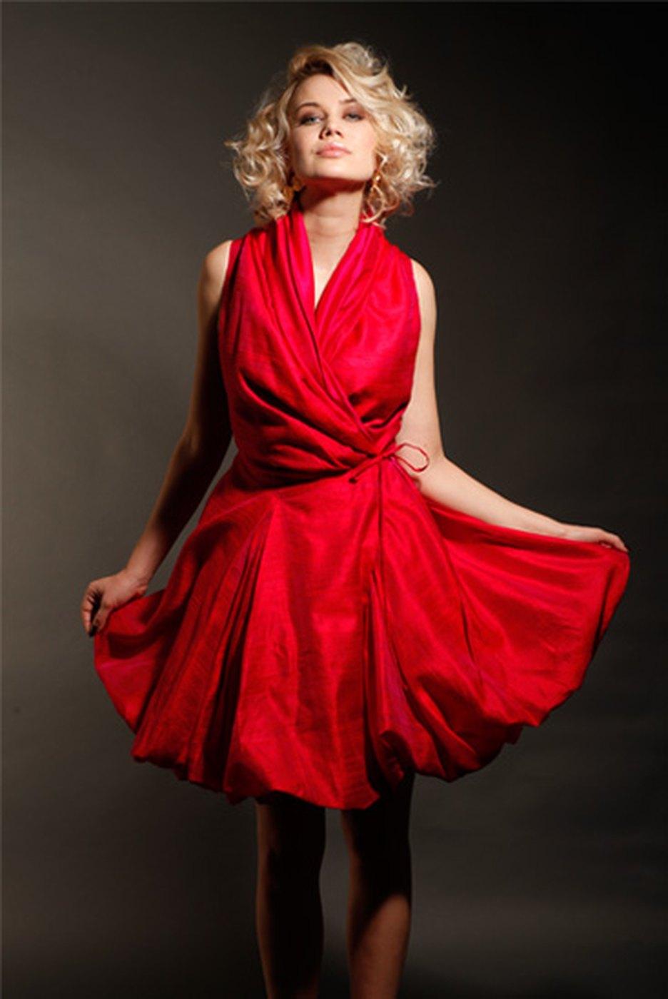 A red silk cocktail dress caught in movement